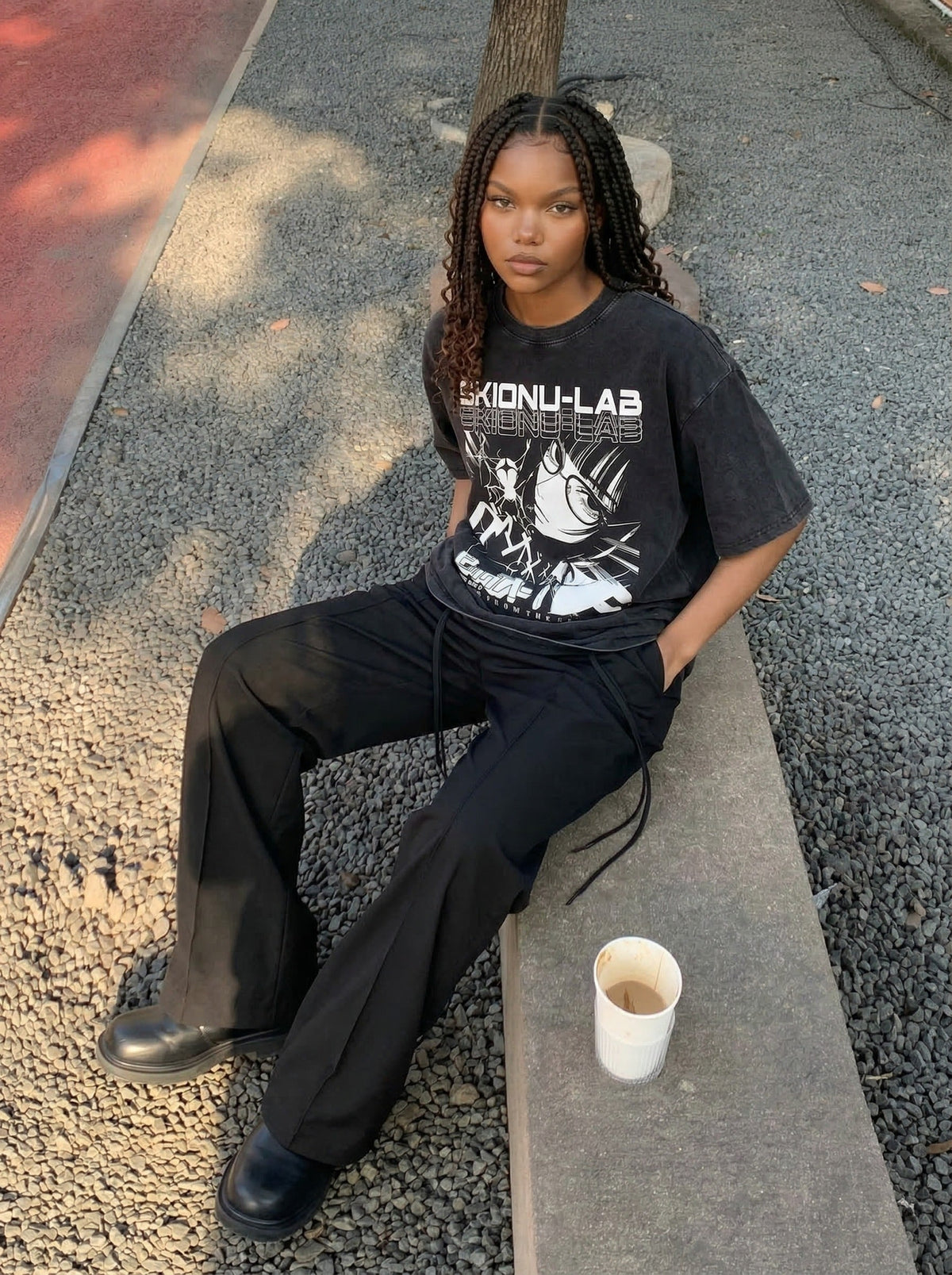 Washed black oversized short-sleeve t-shirt with anime graphic — model photo