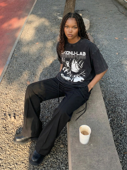 Washed black oversized short-sleeve t-shirt with anime graphic — model photo