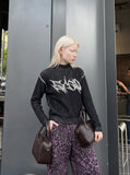 DAXUEN black vertical ribbed abstract graphic mock neck sweater — model photo