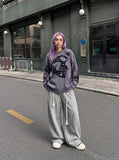 DAXUEN grey oversized distressed skull graphic sweater — model photo