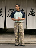 DAXUEN greenish-beige abstract camouflage wide-leg cargo pants — model photo
