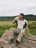 DAXUEN greenish-beige abstract camouflage wide-leg cargo pants — model photo