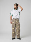DAXUEN greenish-beige abstract camouflage wide-leg cargo pants — model photo