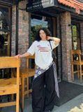 DAXUEN solid color oversized abstract motion graphic t-shirt — model photo