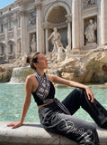 DAXUEN washed black wide-leg abstract-script sweatpants — model photo