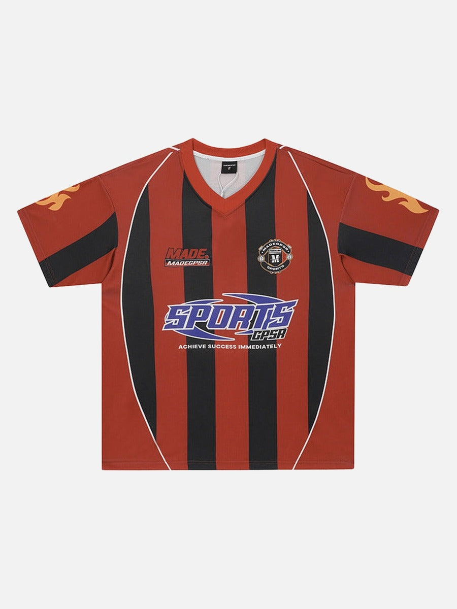 Red and black vertically striped V-neck football jersey with retro sponsor-style chest graphics and flame details on the sleeves