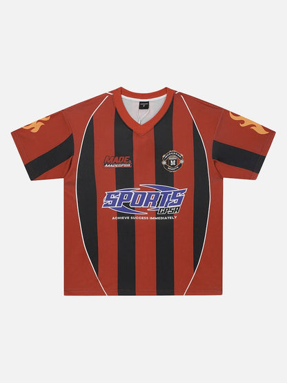 Red and black vertically striped V-neck football jersey with retro sponsor-style chest graphics and flame details on the sleeves