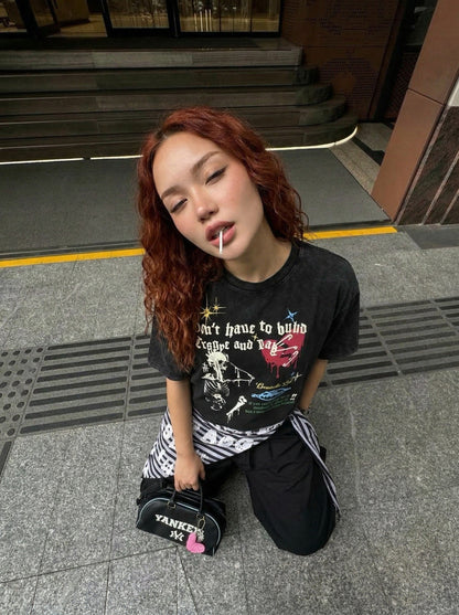 Grungy graphic t-shirt with skull and text — model photo
