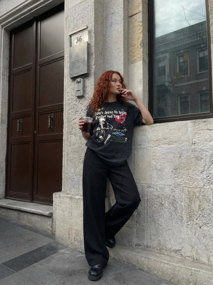 Grungy graphic t-shirt with skull and text — model photo