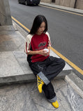DAXUEN black angular crocodile-panel trousers — model photo
