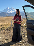 DAXUEN black angular crocodile-panel trousers — model photo