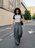 DAXUEN grey wide-leg trousers with asymmetrical button detail — model photo