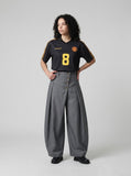 DAXUEN grey wide-leg trousers with asymmetrical button detail — model photo