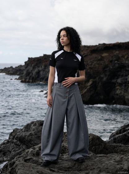DAXUEN grey wide-leg trousers with asymmetrical button detail — model photo