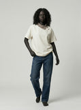 DAXUEN Asymmetrical collar short-sleeve top in cream and black — model photo