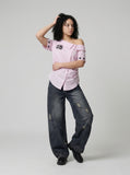 DAXUEN Women's asymmetrical off-shoulder shirt with stripes and graphic — model photo