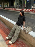 DAXUEN Asymmetrical snap button short-sleeved T-shirt — model photo