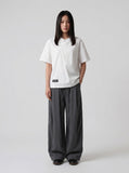 DAXUEN Asymmetrical snap button short-sleeved T-shirt — model photo