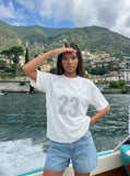 DAXUEN Athletic Energy Graphic T-Shirt with numeral and text graphics — model photo
