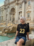 DAXUEN Athletic Energy Graphic T-Shirt with numeral and text graphics — model photo