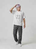 DAXUEN Athletic Energy Graphic T-Shirt with numeral and text graphics — model photo