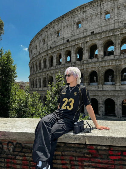 DAXUEN Athletic Energy Graphic T-Shirt with numeral and text graphics — model photo