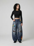DAXUEN Baggy blue denim jeans with graphic patches — model photo