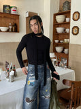 DAXUEN Baggy blue denim jeans with graphic patches — model photo