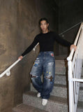 DAXUEN Baggy blue denim jeans with graphic patches — model photo