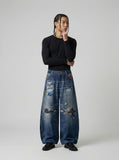 DAXUEN Baggy blue denim jeans with graphic patches — model photo