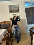 DAXUEN Baggy blue denim jeans with graphic patches — model photo