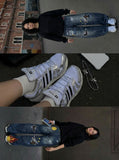 DAXUEN Baggy blue denim jeans with graphic patches — model photo