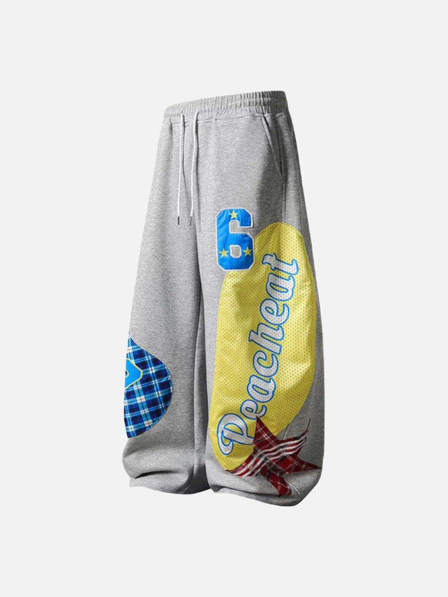 Grey wide-leg sweatpants with patchwork designs