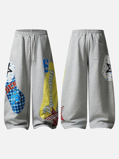 Grey wide-leg sweatpants with patchwork designs