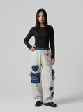 DAXUEN Wide-leg striped pants with patches and embroidery — model photo