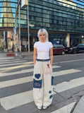 DAXUEN Wide-leg striped pants with patches and embroidery — model photo