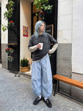 DAXUEN Baggy utility pants with plaid tie and print — model photo