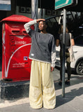 DAXUEN Baggy utility pants with plaid tie and print — model photo