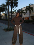DAXUEN Baggy wide-leg pants with script prints — model photo