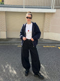DAXUEN Men's baggy wide-leg trousers in solid black and beige — model photo