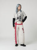 DAXUEN Loose-fitting wide-leg track pants with red graphics — model photo