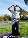 DAXUEN BANGOULUOU Graphic T-Shirt with floral and cartoon prints — model photo