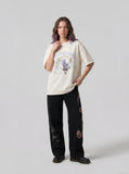 DAXUEN BANGOULUOU Graphic T-Shirt with floral and cartoon prints — model photo