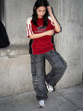 DAXUEN faded blue cargo jeans with barbed wire embroidery — model photo