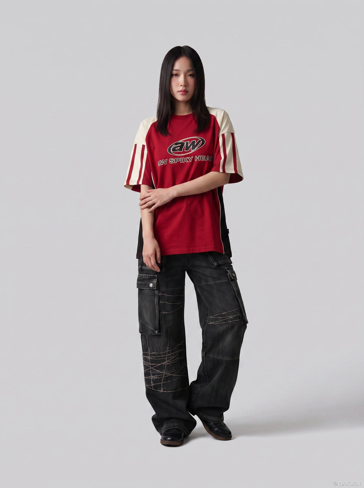 DAXUEN faded blue cargo jeans with barbed wire embroidery — model photo