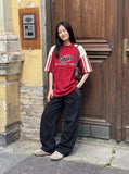 DAXUEN black oversized balloon pants with silver studs — model photo