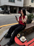 DAXUEN black oversized balloon pants with silver studs — model photo