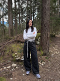 DAXUEN black oversized balloon pants with silver studs — model photo