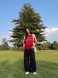 DAXUEN black oversized balloon pants with silver studs — model photo