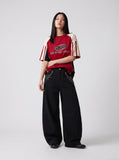 DAXUEN black oversized balloon pants with silver studs — model photo